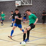 A group of boys playing indoor football.
